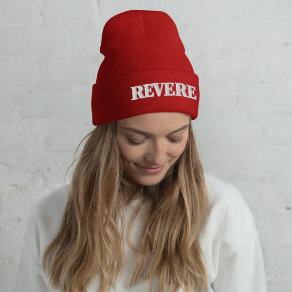 woman wearing red beanie with Revere embroidered graphic