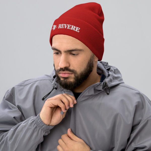 Man wearing red beanie with Revere 1801 embroidered graphic
