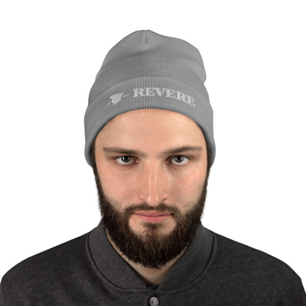 man wearing light grey beanie with Revere 1801 embroidered graphic