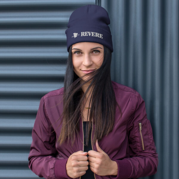 woman wearing blue beanie with Revere 1801 embroidered graphic