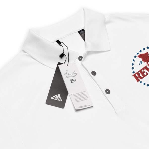 close up of a white polo shirt with Red and blue Revere embroidered logo
