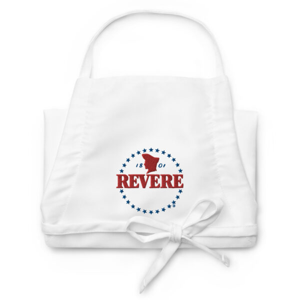 folded white apron with blue and red Revere logo