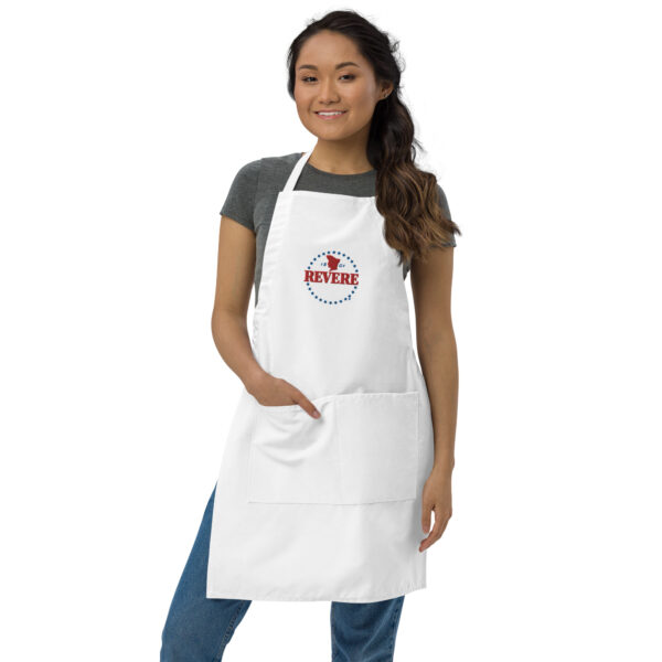 woman in white apron with blue and red Revere logo