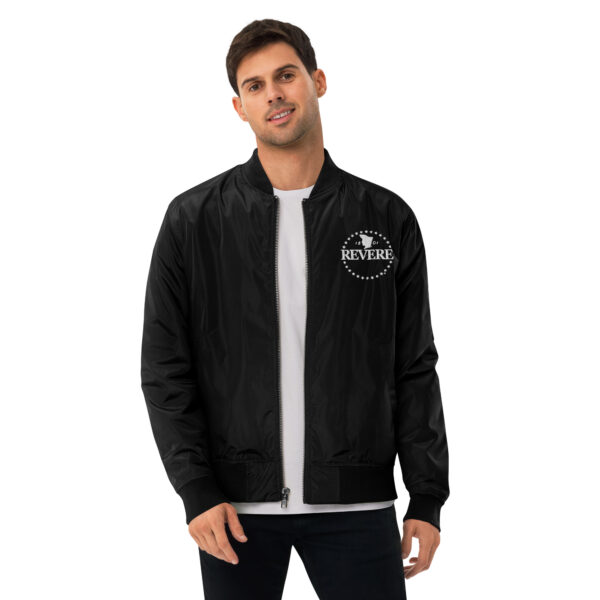 man in black bomber jacket with white Revere logo